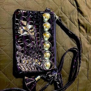 Crocodile patterned shiny purple clutch bag.